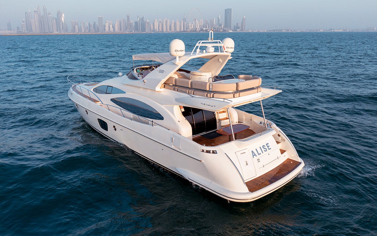 Dubai Marina luxury yacht cruising with city skyline in the background.