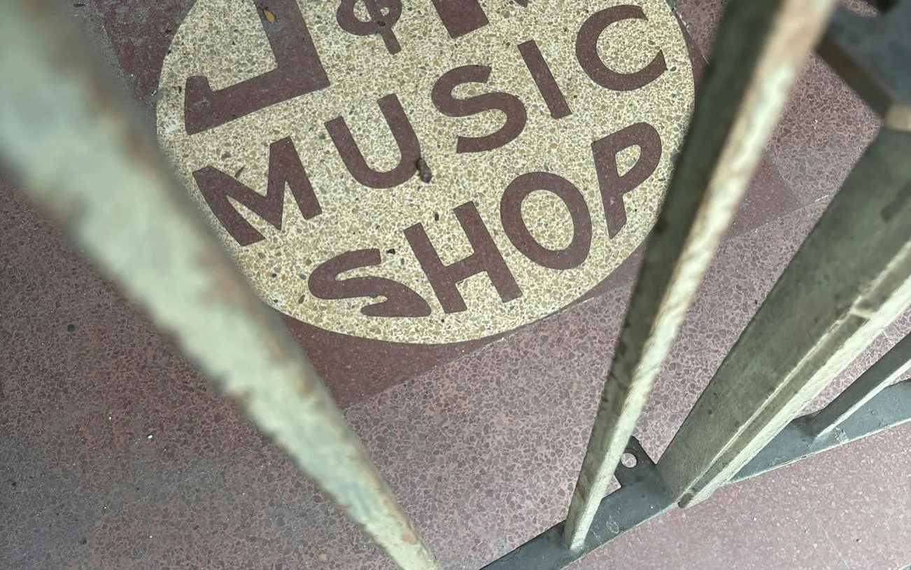 Music shop entrance sign in New Orleans, part of a self-guided city exploration game.