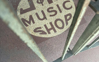 Music shop entrance sign in New Orleans, part of a self-guided city exploration game.