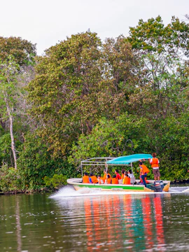 Boat tour with passengers in life jackets at Weston Wetland Park.