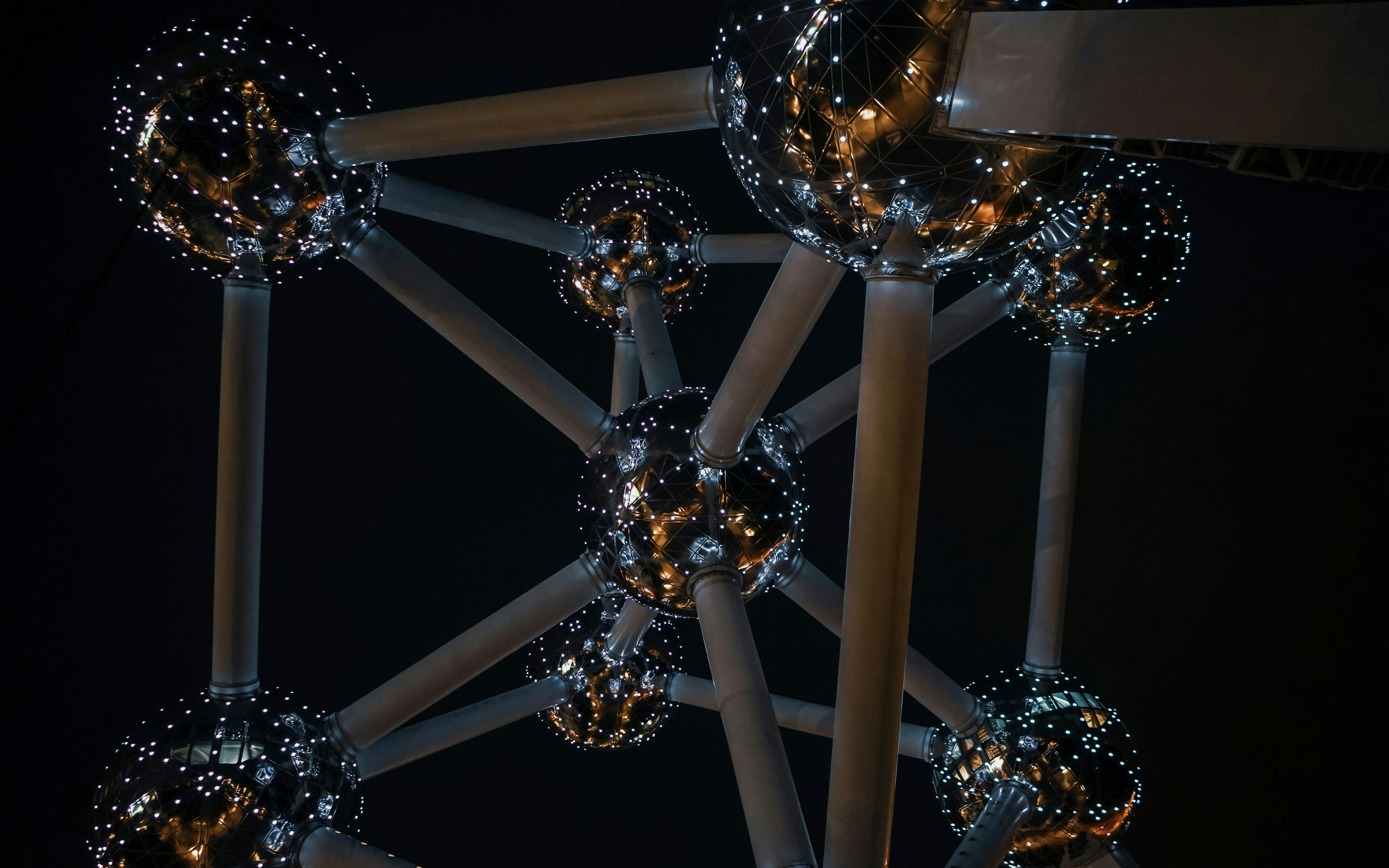 Atomium structure illuminated at night in Brussels.