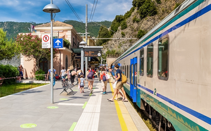 Train station in Cinque Terre with passengers boarding from La Spezia.