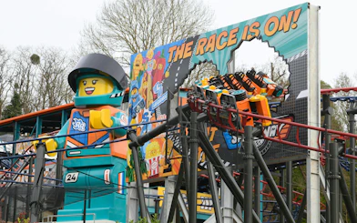 Lego racer statue and roller coaster at Legoland Windsor.
