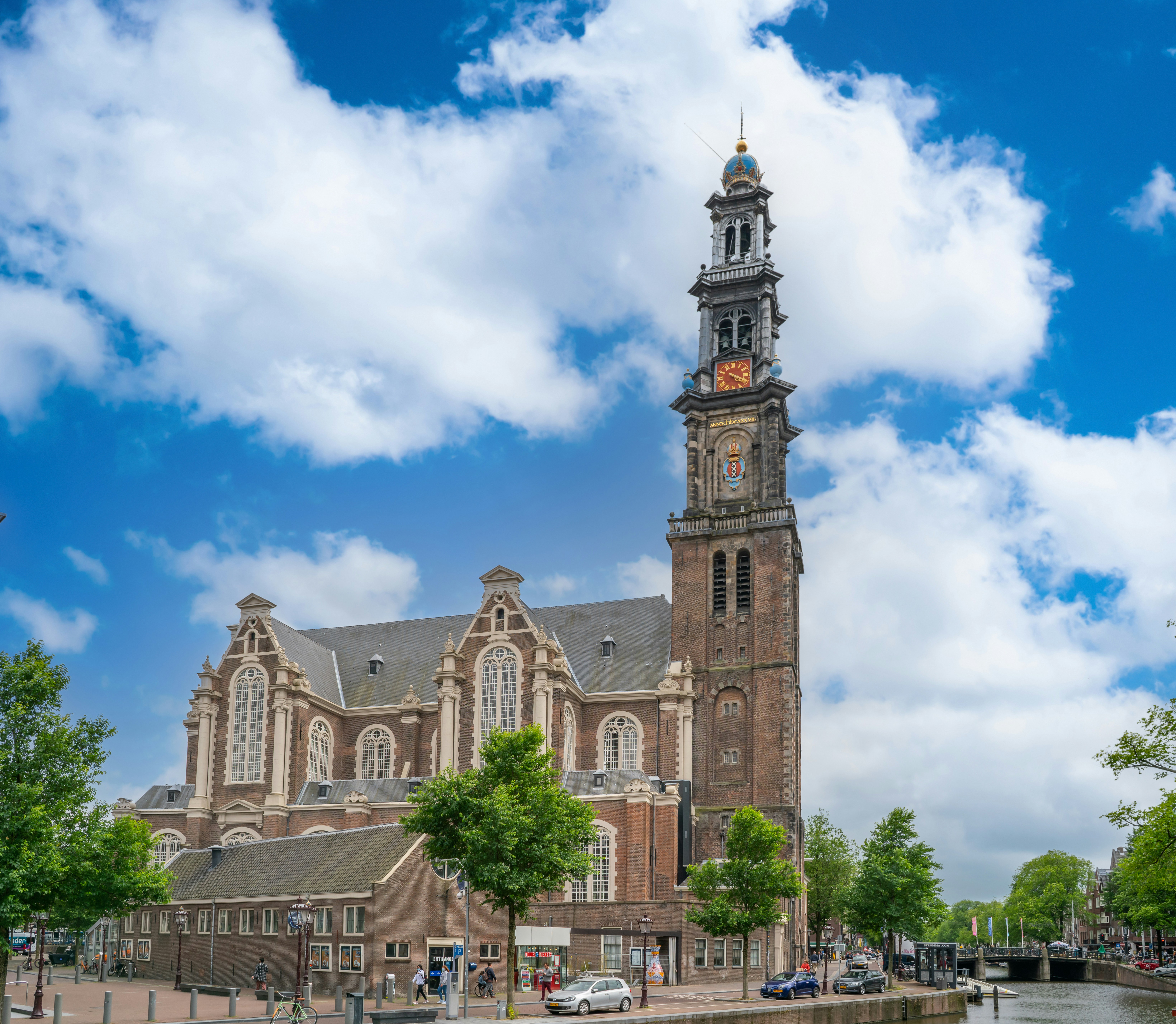 Westerkerk church tower and canal in Amsterdam, Netherlands.