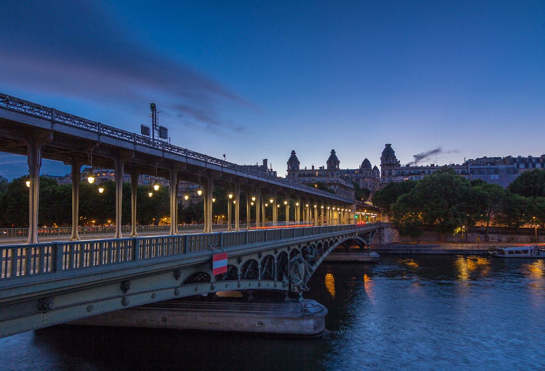 Pont de Bir-Hakeim illuminated at night with Eiffel Tower in the background, Paris, France.