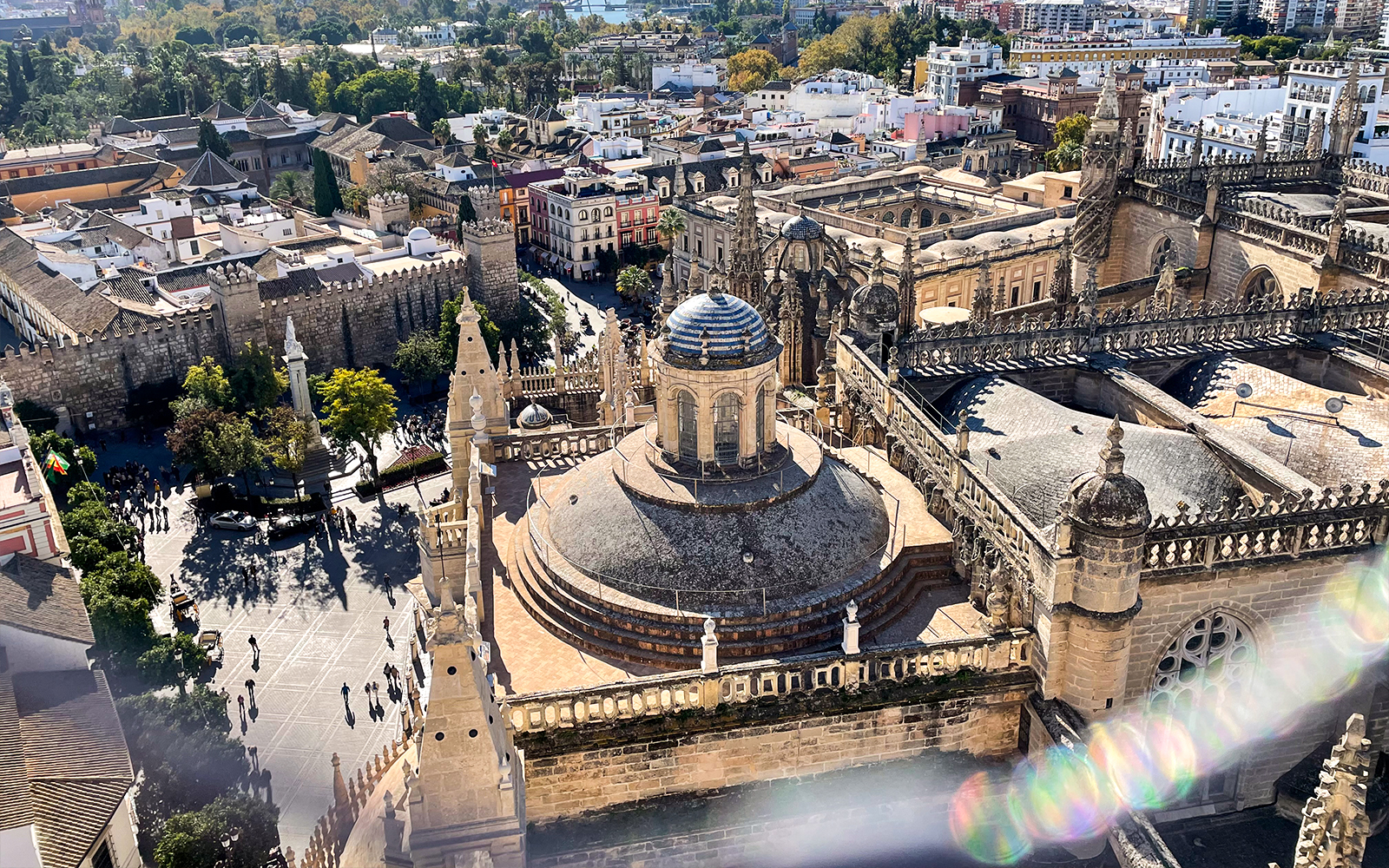 Aerial view of Seville Cathedral and Giralda tower with surrounding cityscape.