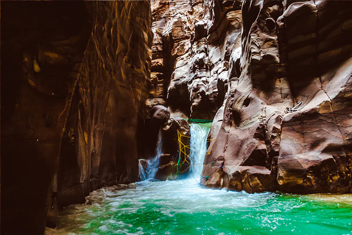 Wadi Mujib Siq Trail canyon with flowing water and rock formations, Amman.