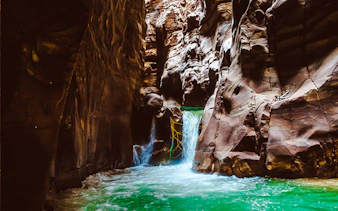 Wadi Mujib Siq Trail canyon with flowing water and rock formations, Amman.