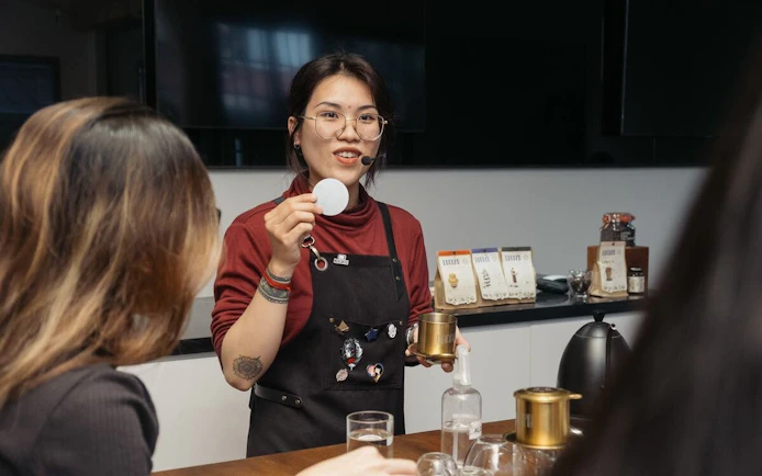 Vietnamese coffee workshop with instructor demonstrating brewing techniques.