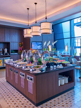 Buffet spread at Plaza Premium Lounge Jakarta with seating area and modern decor.