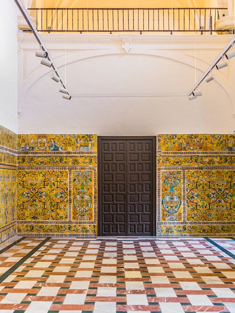 Decorative tile walls inside the Alcázar of Seville, Spain.