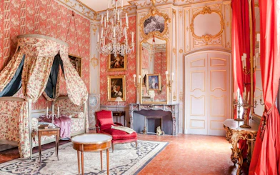 Elegant room with ornate decor and paintings at Caumont Centre d’Art, Aix-en-Provence.