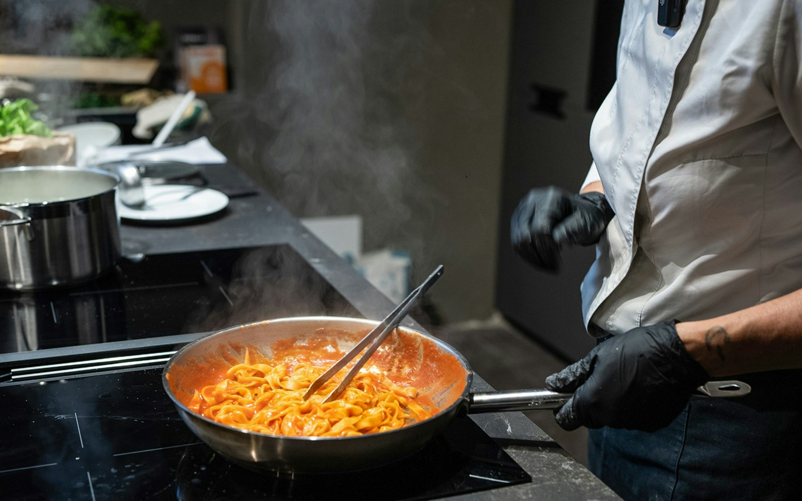 Chef preparing pasta in a cooking class in Rome.