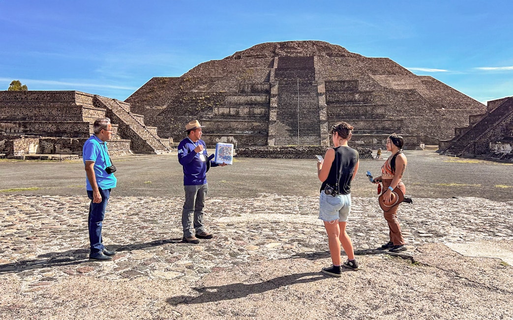 Tour group with guide at Pyramid of the Moon, Teotihuacan, Mexico.