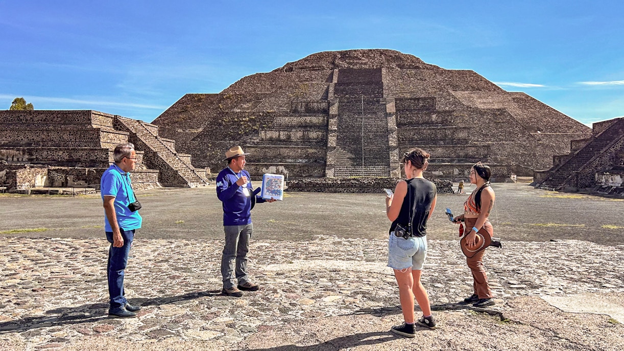 Guided tour group exploring Pyramid of the Moon, Teotihuacan, Mexico.