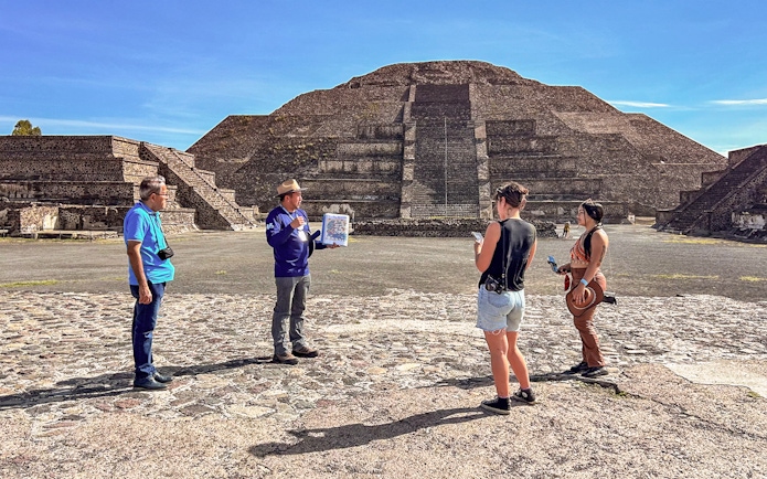 Tour group with guide at Pyramid of the Moon, Teotihuacan, Mexico.