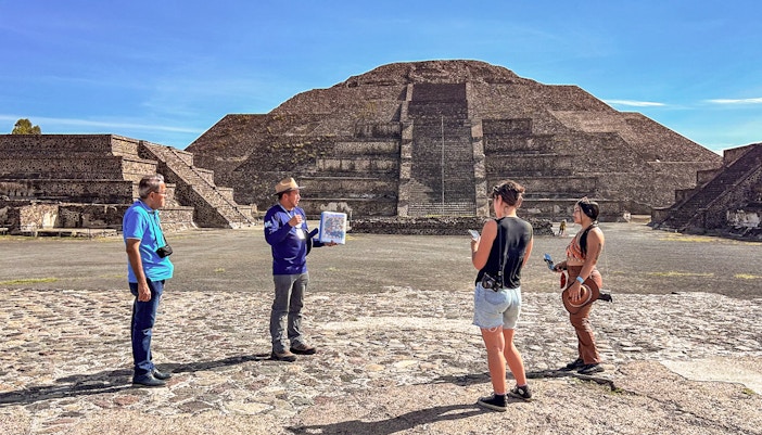 Tour group with guide at Pyramid of the Moon, Teotihuacan, Mexico.