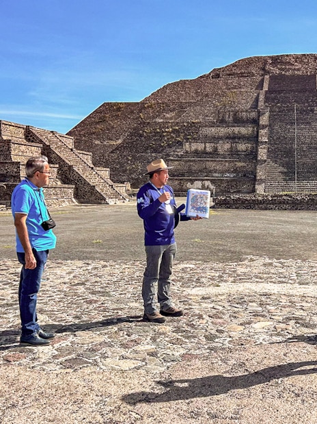 Tour group with guide at Pyramid of the Moon, Teotihuacan, Mexico.