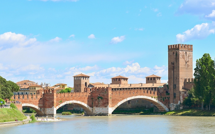 Verona's Castelvecchio Bridge over the Adige River on a sunny day.
