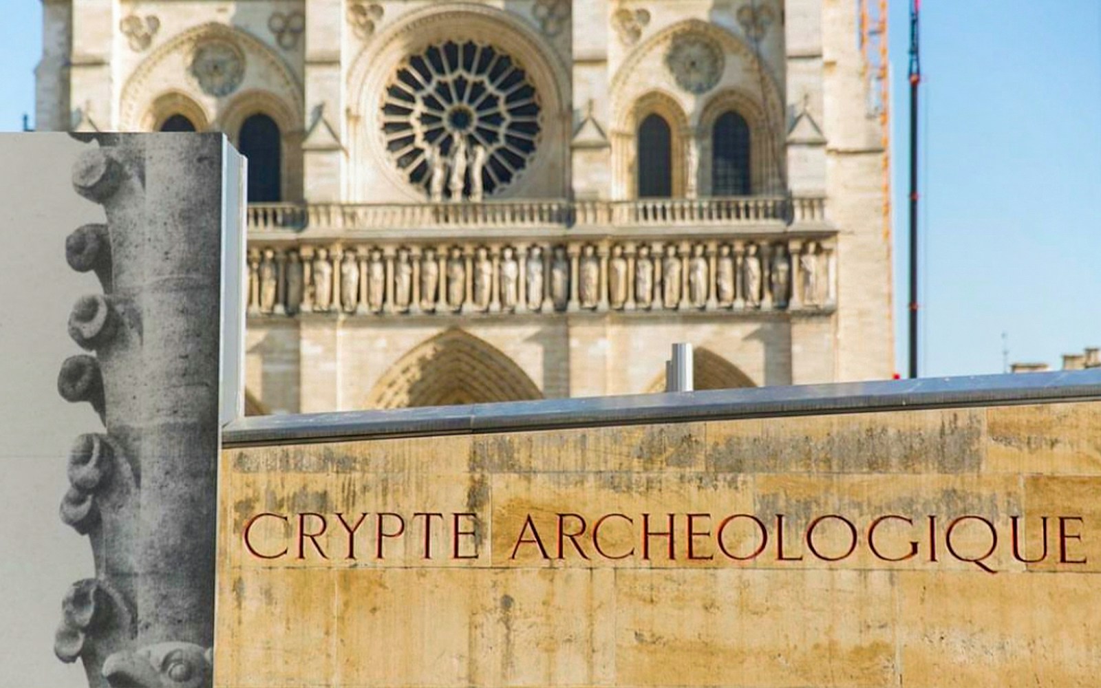 Notre-Dame Archaeological Crypt entrance with historical artifacts displayed.