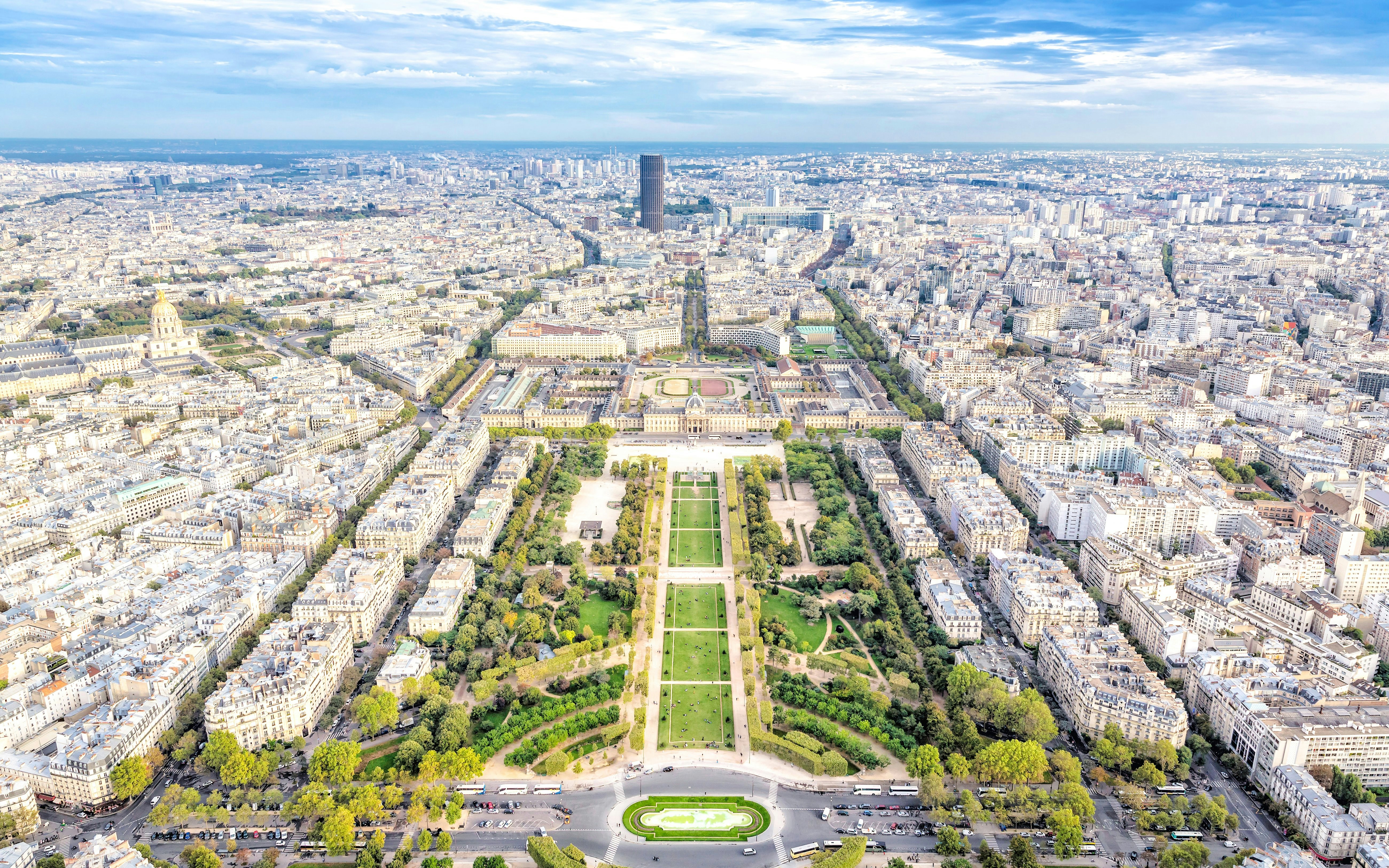 Aerial view of Paris from Montparnasse Tower, showcasing the Eiffel Tower and Champ de Mars.