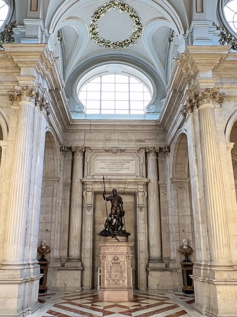 Hall of columns with chandeliers and statue, Royal Palace of Madrid.