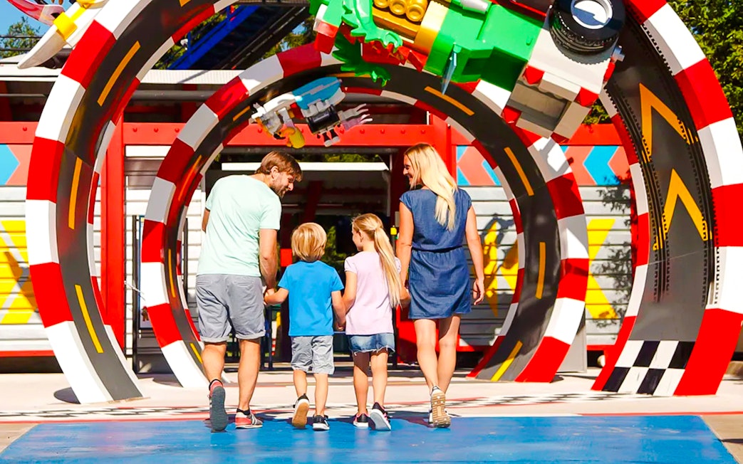 Family walking through colorful arch at LEGOLAND Deutschland.