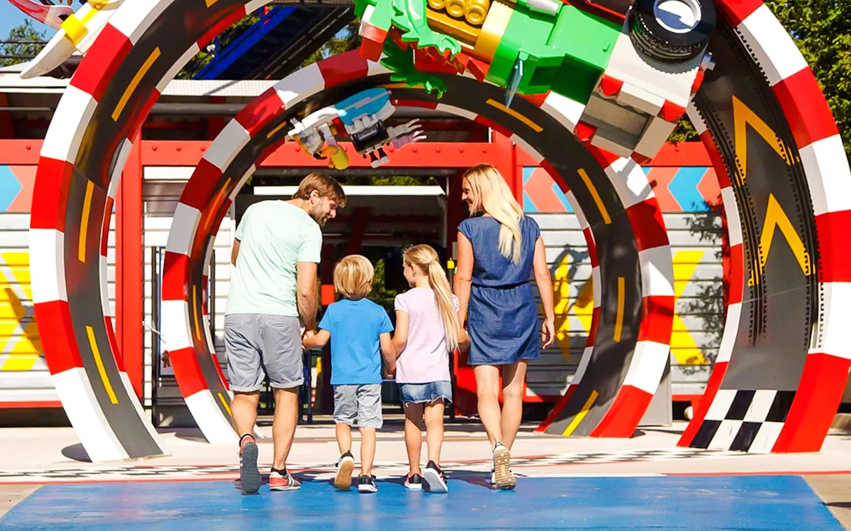 Family walking through colorful arch at LEGOLAND Deutschland.
