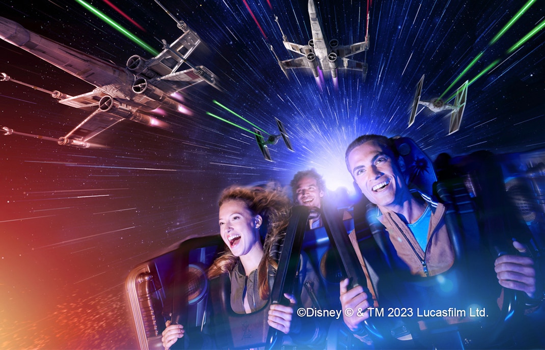 Riders on Star Wars Hyperspace Mountain at Disneyland Paris with X-wing and TIE fighters.