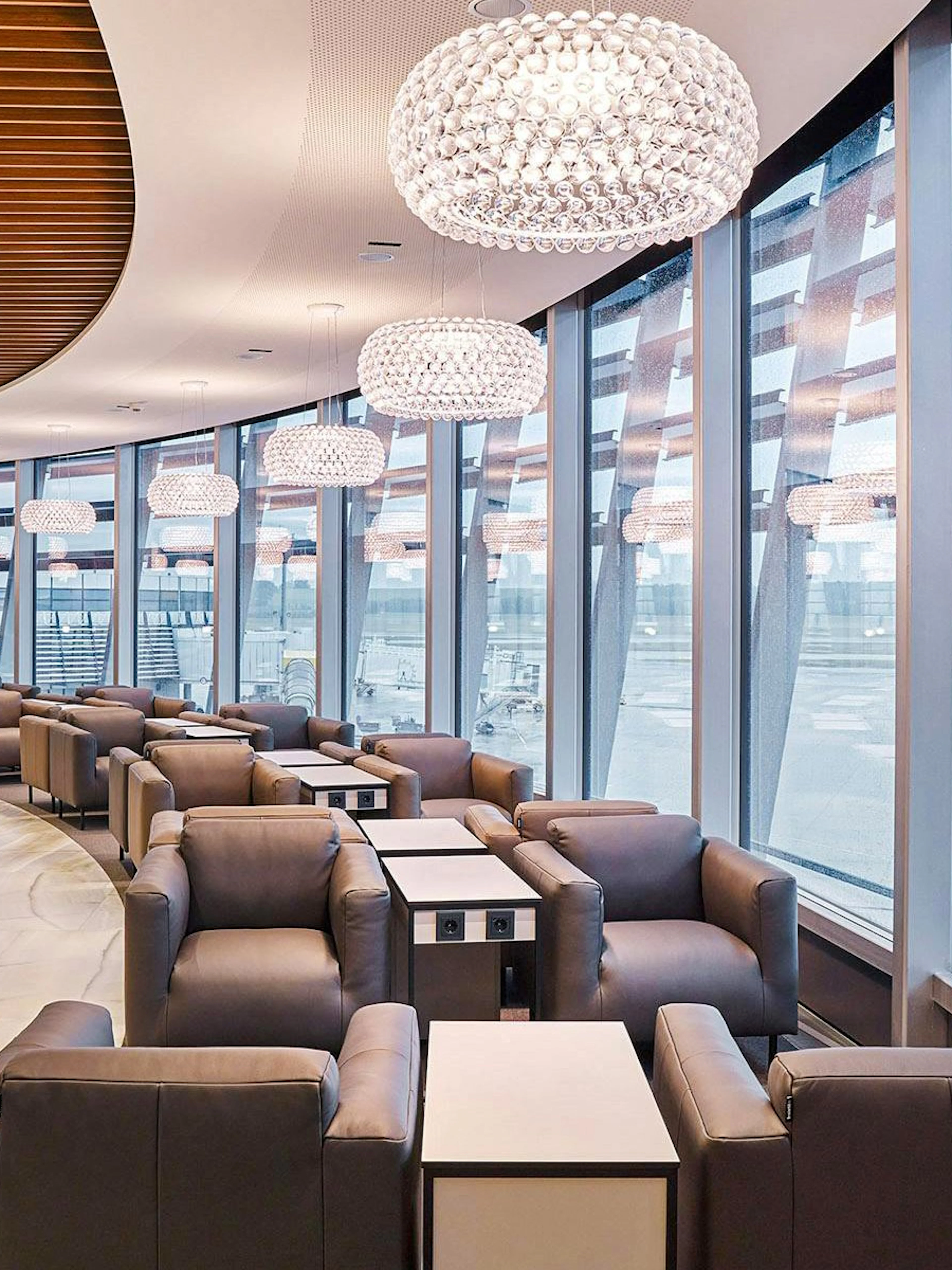 Vienna Lounge seating area with large windows at Vienna Airport Terminal 1.