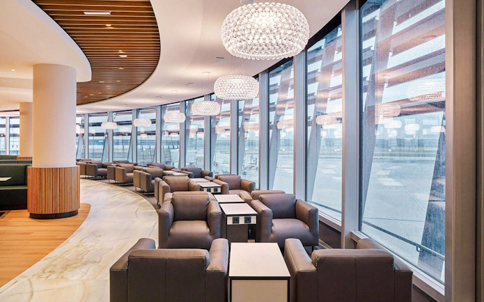 Vienna Lounge seating area with large windows at Vienna Airport Terminal 1.