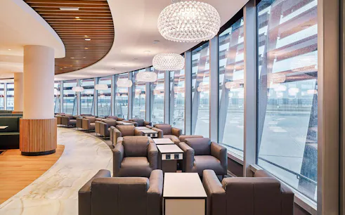 Vienna Lounge seating area with large windows at Vienna Airport Terminal 1.