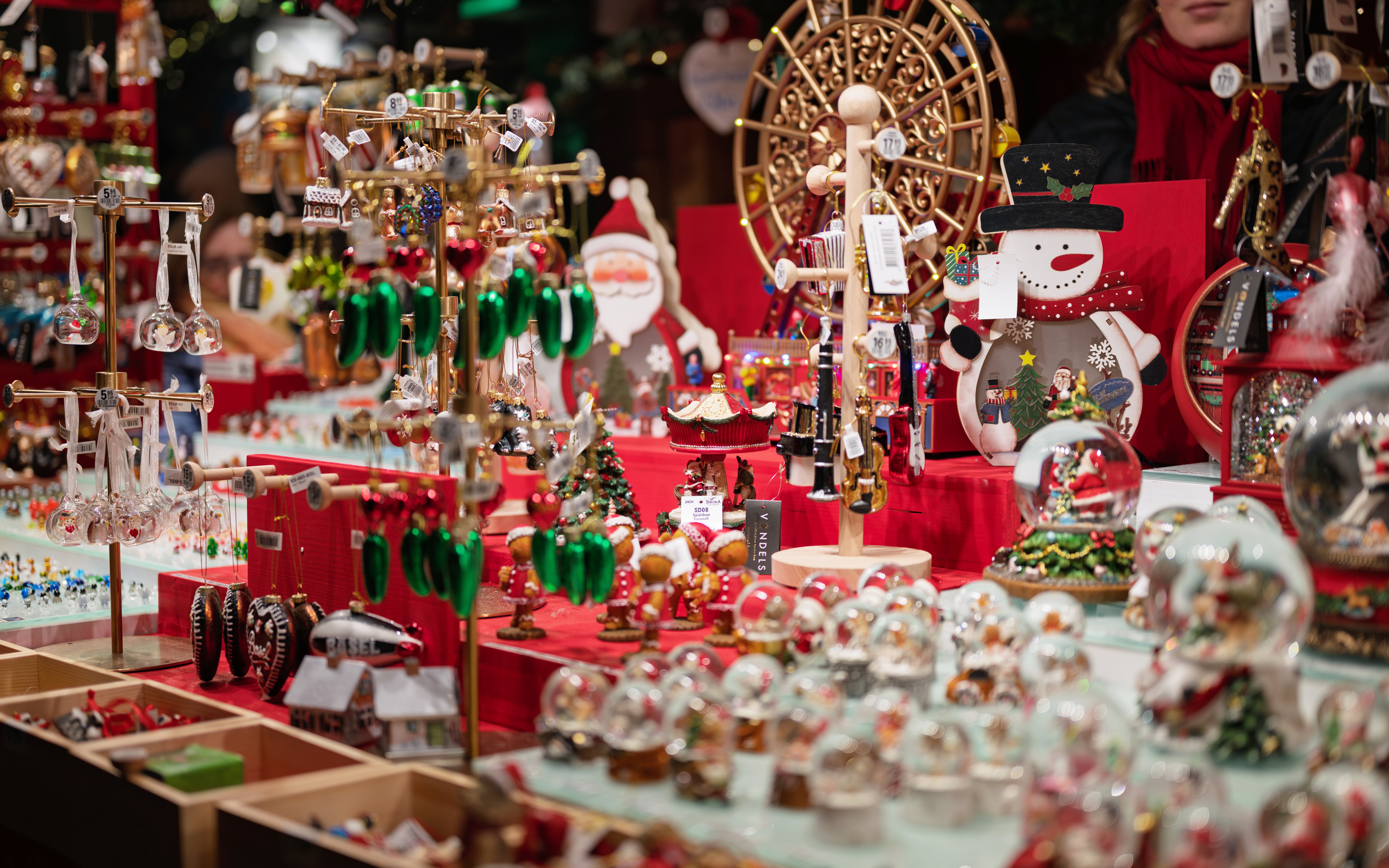 Christmas market stall with festive decorations and ornaments on display.