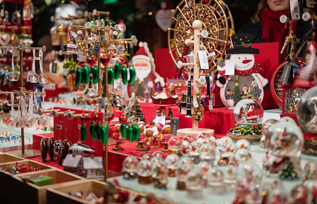 Christmas market stall with festive decorations and ornaments on display.