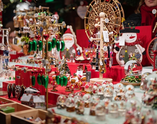 Christmas market stall with festive decorations and ornaments on display.
