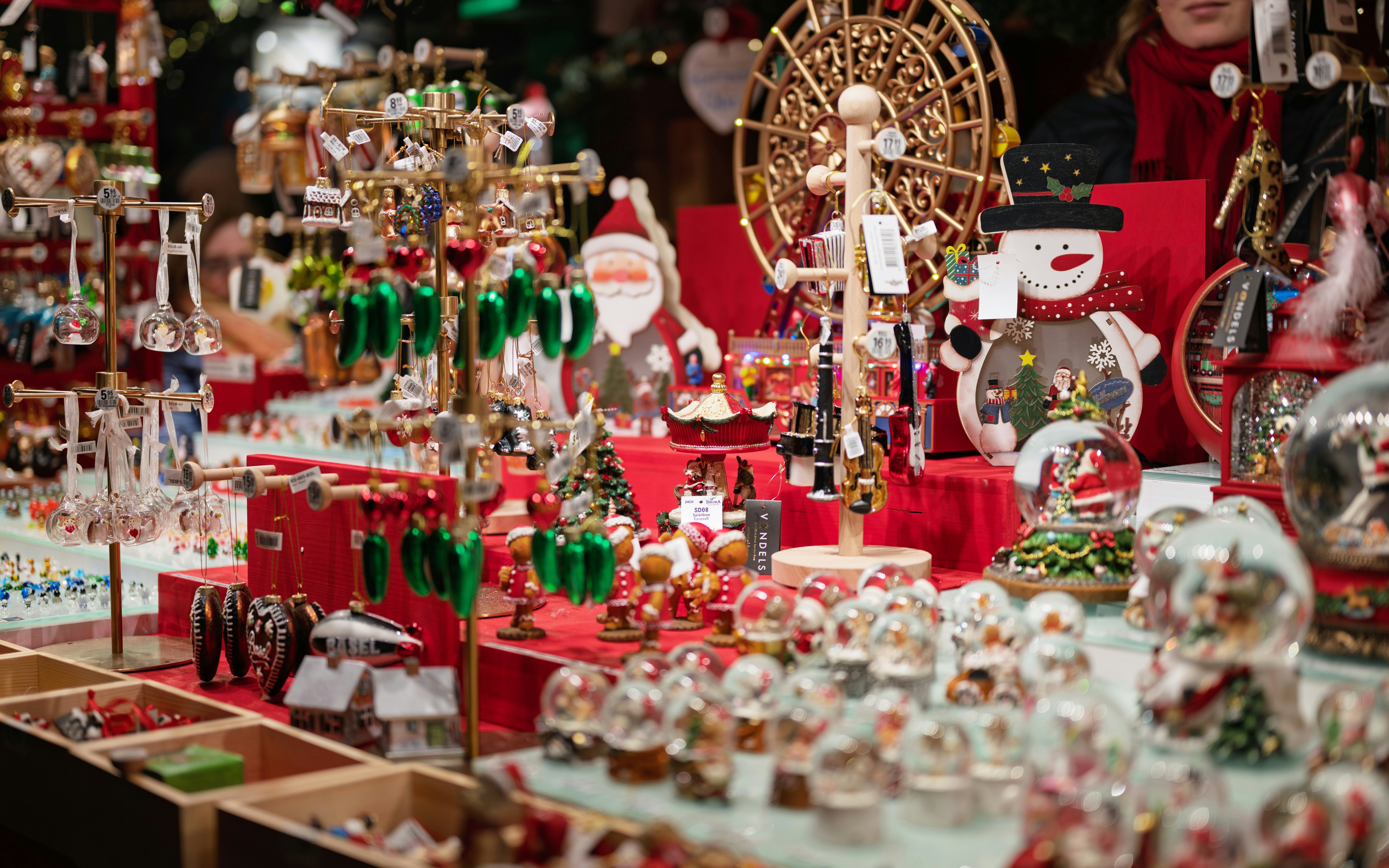 Christmas market stall with festive decorations and ornaments on display.