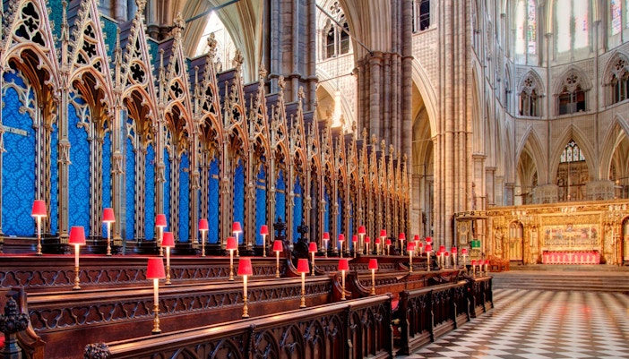 Westminster Abbey interior with ornate choir stalls and altar, Royal London Tour.