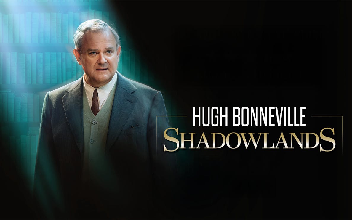 Actor in a suit with "Shadowlands" text on a dark background.