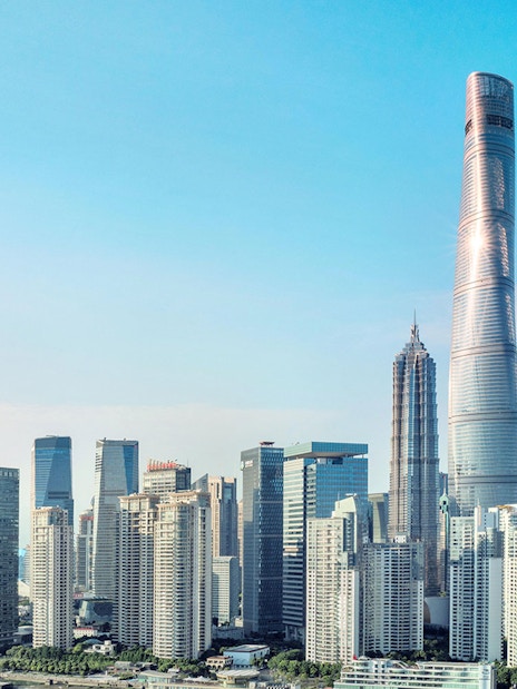 Shanghai skyline featuring the Shanghai Tower and surrounding skyscrapers.