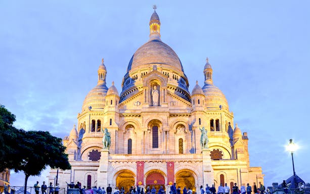 Sacré-Cœur Basilica illuminated at dusk, Montmartre, Paris.