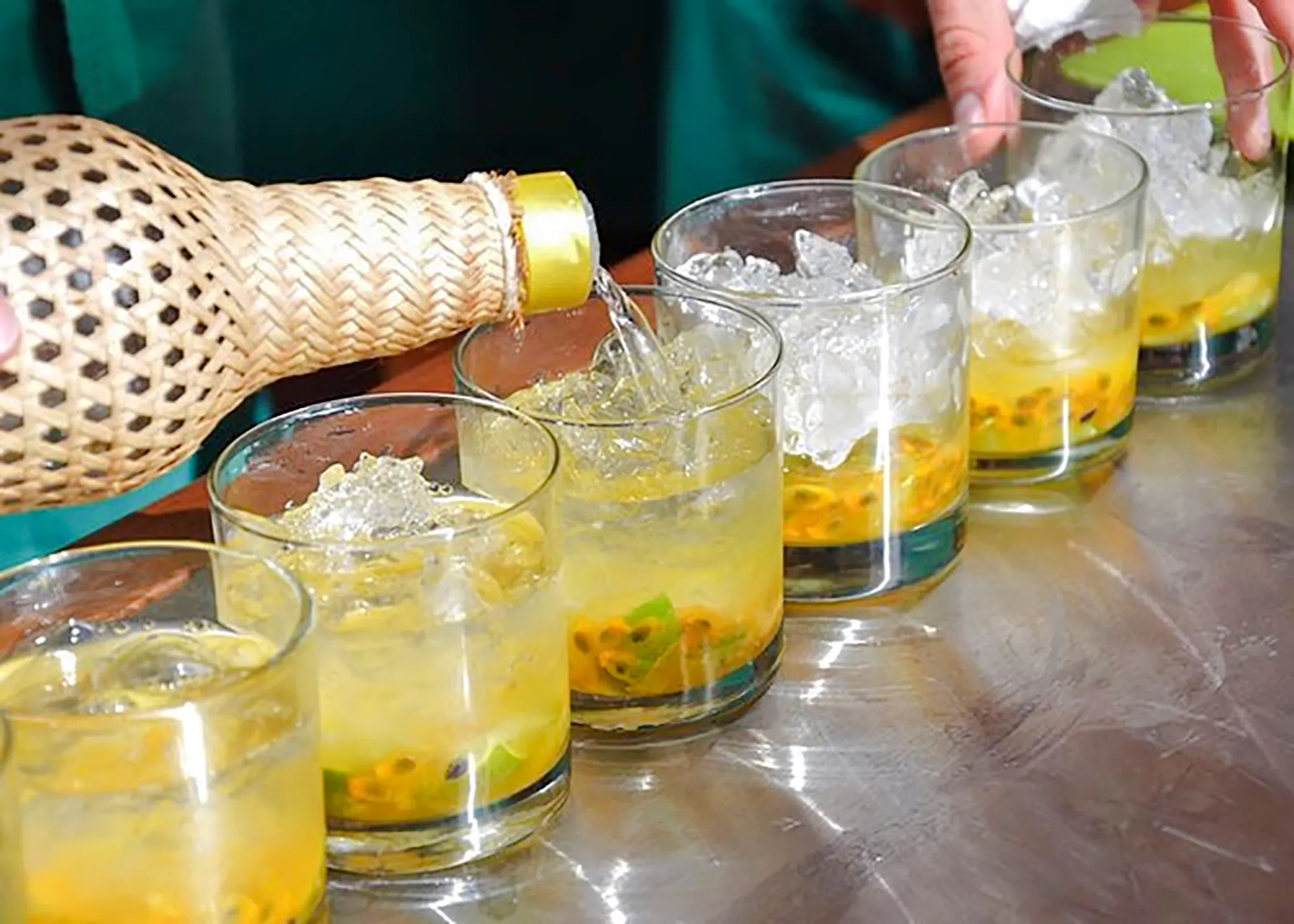 Pouring traditional Brazilian cocktails during cooking class in Copacabana, Rio de Janeiro.