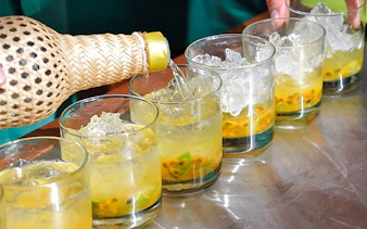 Pouring traditional Brazilian cocktails during cooking class in Copacabana, Rio de Janeiro.