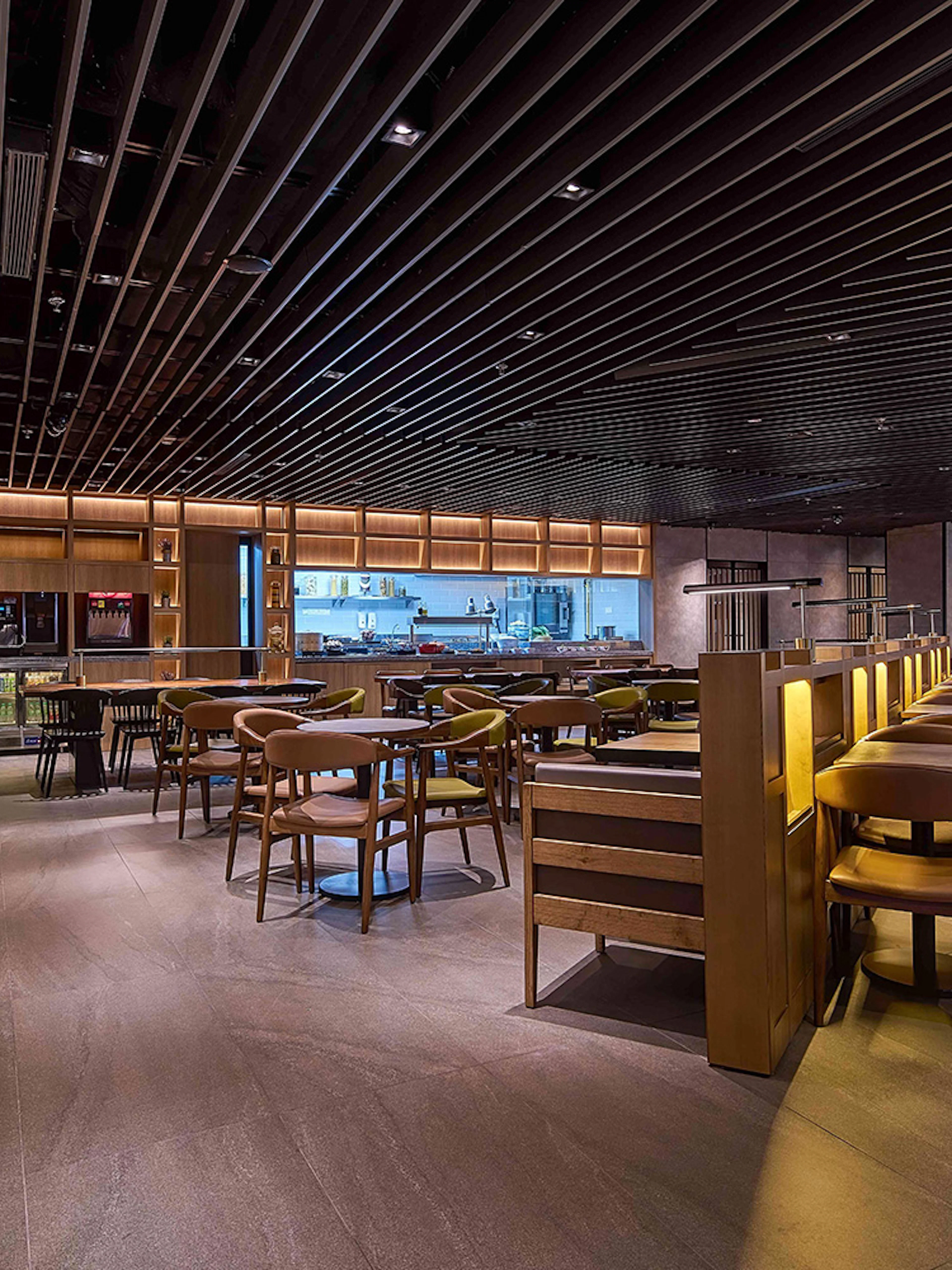 Plaza Premium First lounge seating area with dining tables and buffet counter at Satellite Terminal.