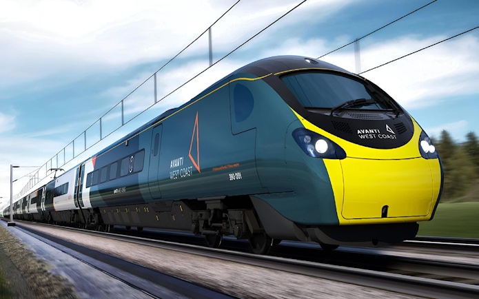 High-speed train traveling through countryside on Lake District day tour from London.