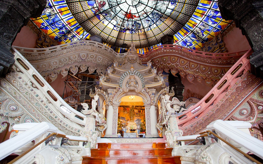 Erawan Museum interior with ornate staircase and stained glass ceiling, Bangkok, Thailand.