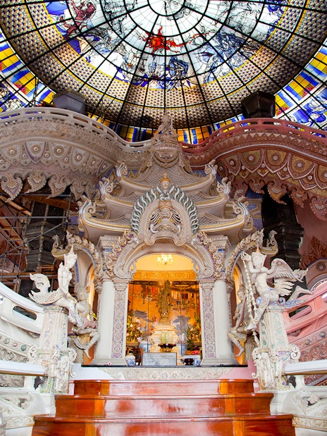 Erawan Museum interior with ornate staircase and stained glass ceiling, Bangkok, Thailand.