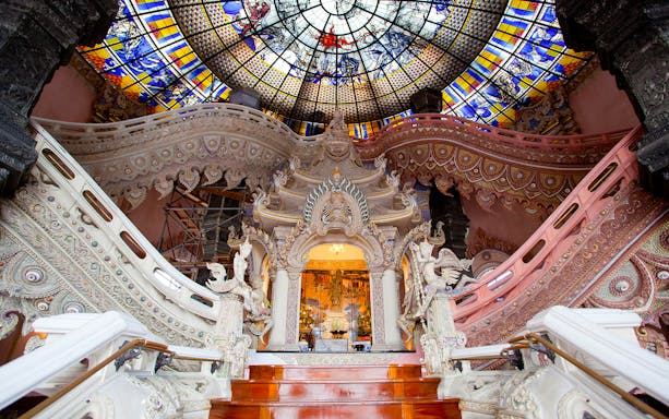 Erawan Museum interior with ornate staircase and stained glass ceiling, Bangkok, Thailand.