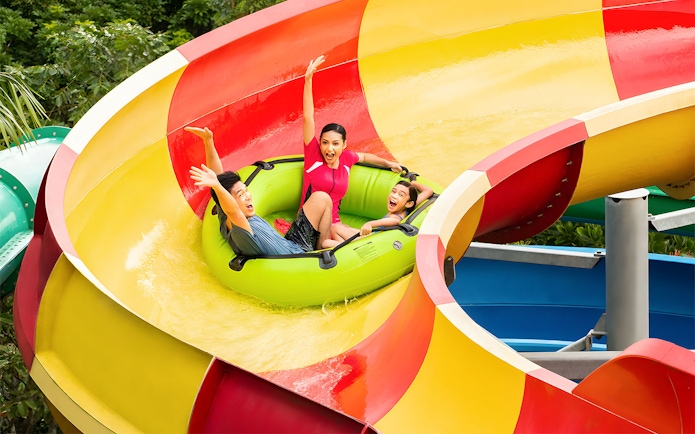 Family enjoying a water slide at LEGOLAND Malaysia Water Park.