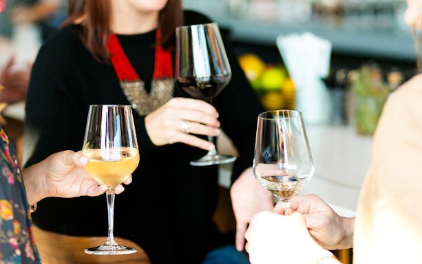 Wine glasses toasting during Etna wine-tasting experience.