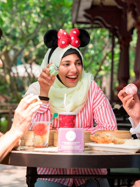 People enjoying food at Disneyland Hong Kong.